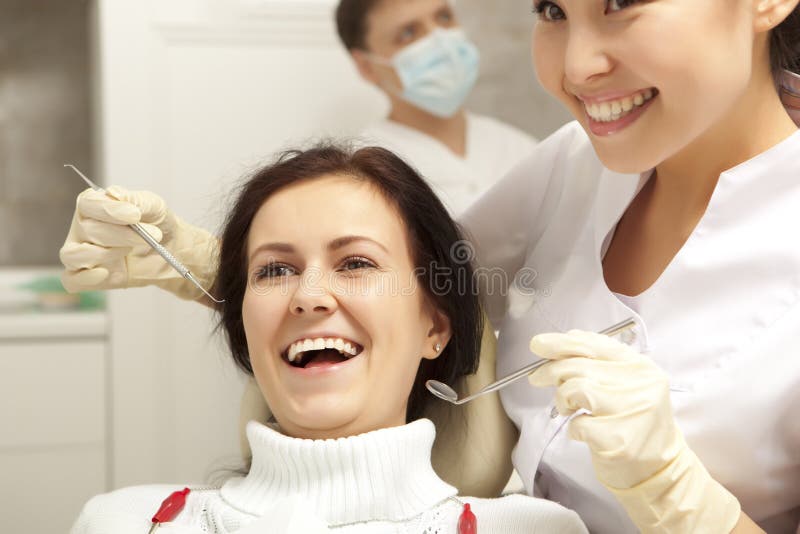 Stomatology concept - dentist with mirror checking patient girl royalty free stock images Stomatology concept - dentist with mirror checking patient girl royalty free stock images