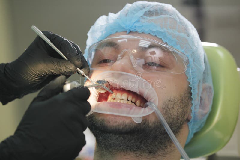 Stomatology healthcare - male patient at dentist`s chair stock photos Stomatology healthcare - male patient at dentist`s chair stock photos