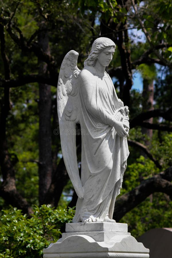 Stone Angel. Gravestone in peaceful cemetery stock photo Stone Angel. Gravestone in peaceful cemetery stock photo