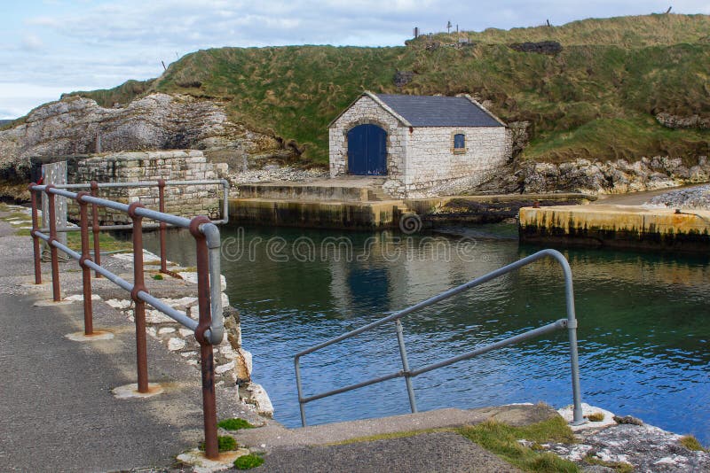 The stone boathouse in the harbor at Ballintoy on the North Coast of Antrim in Ireland