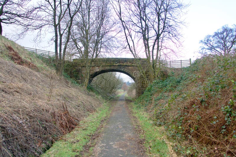 Stone bridge crossing a country path.