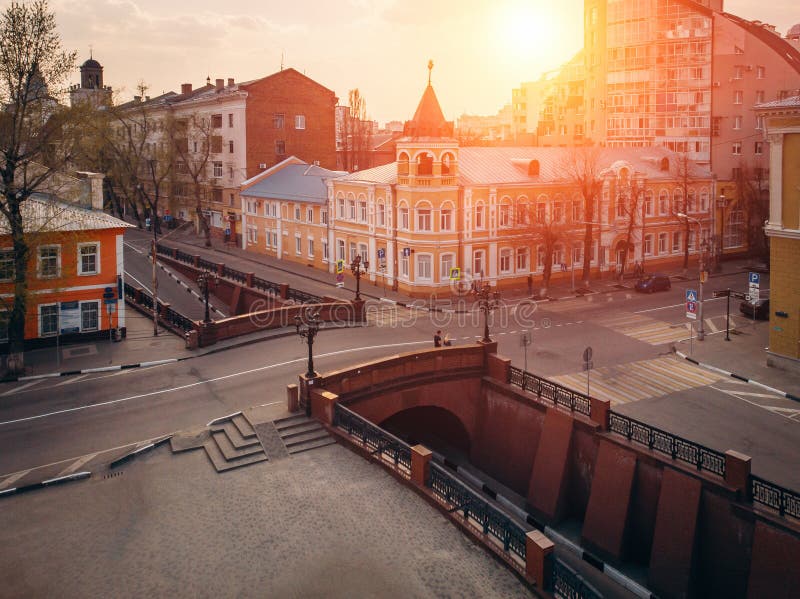 Stone Bridge in historical center of  Voronezh at sunset. Old buildings and road intersection in European city downtown