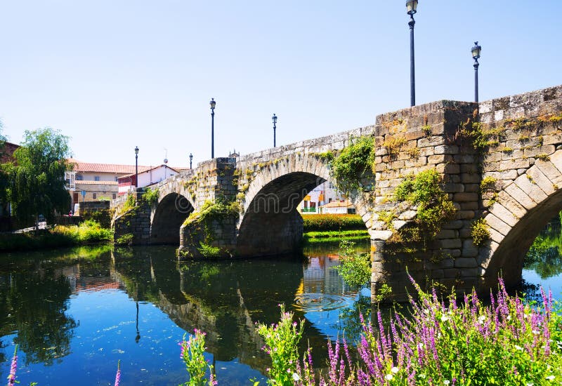 Cabe river and old stone bridge at Monforte de Lemos in summer day