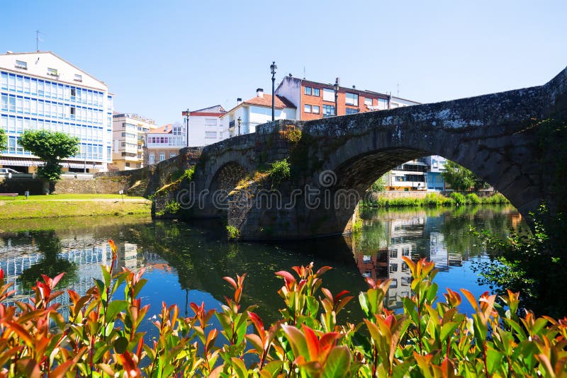 Stone bridge at Monforte de Lemos in summer day. Galicia, Spain
