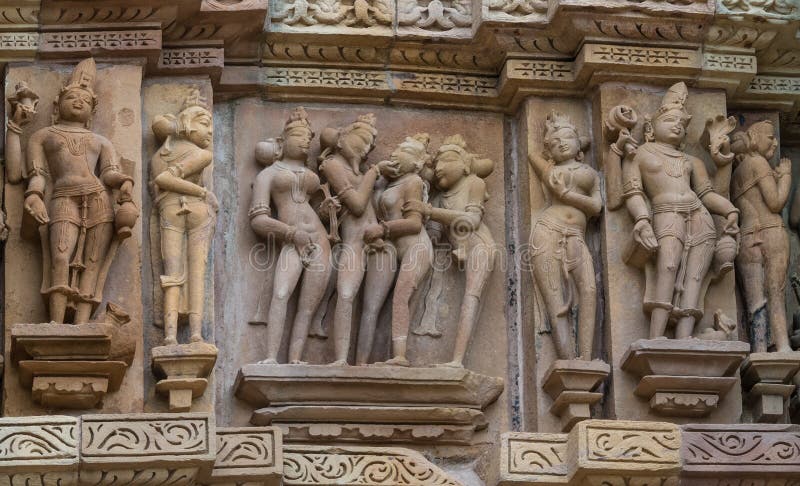 Stone carved erotic bas relief in Hindu temple in Khajuraho, India.