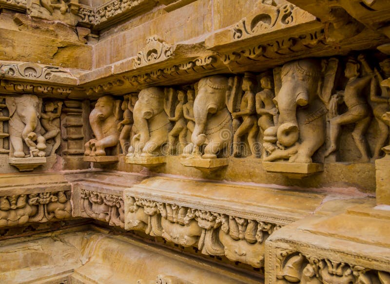 Stone carved erotic scene with elephants in Kahjuraho ancient temple, India