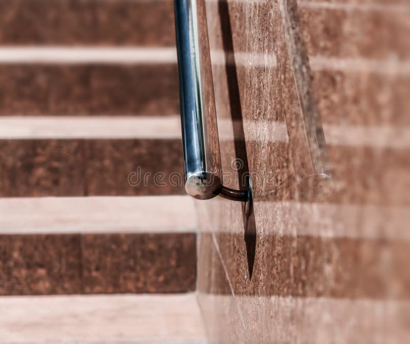 Stone granite stairs steps background with metallic aluminium handle. Red brown modern stairs stock images Stone granite stairs steps background with metallic aluminium handle. Red brown modern stairs stock images