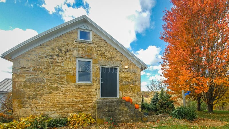 Stone House with Pumpkins on Step and Bright Orange Tree royalty free stock photo Stone House with Pumpkins on Step and Bright Orange Tree royalty free stock photo