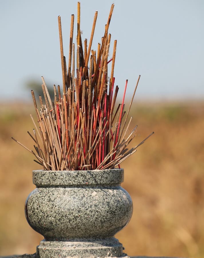Stone Pot with Incense Sticks and Row of Votive Offerings in the Chion