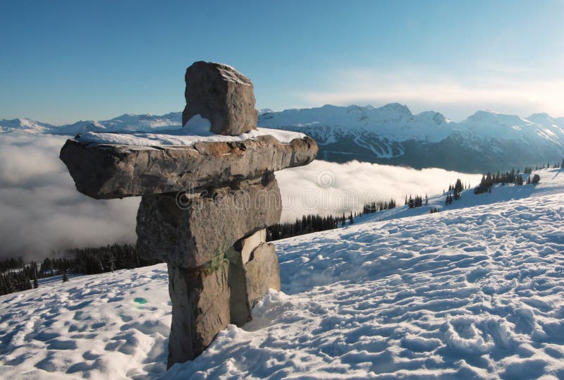 An inukshuk stands sentry over Whistler and Blackcombs mountain, British Columbia, Canada. An inukshuk stands sentry over Whistler and Blackcombs mountain, British Columbia, Canada.