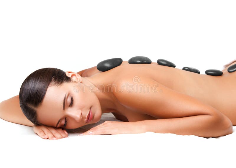 Stone Massage. Beautiful Woman Getting Spa Hot Stones Massage. Spa Salon.