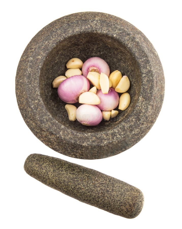 Stone mortar and pestle with onions and garlic over white background. Stone mortar and pestle with onions and garlic over white background