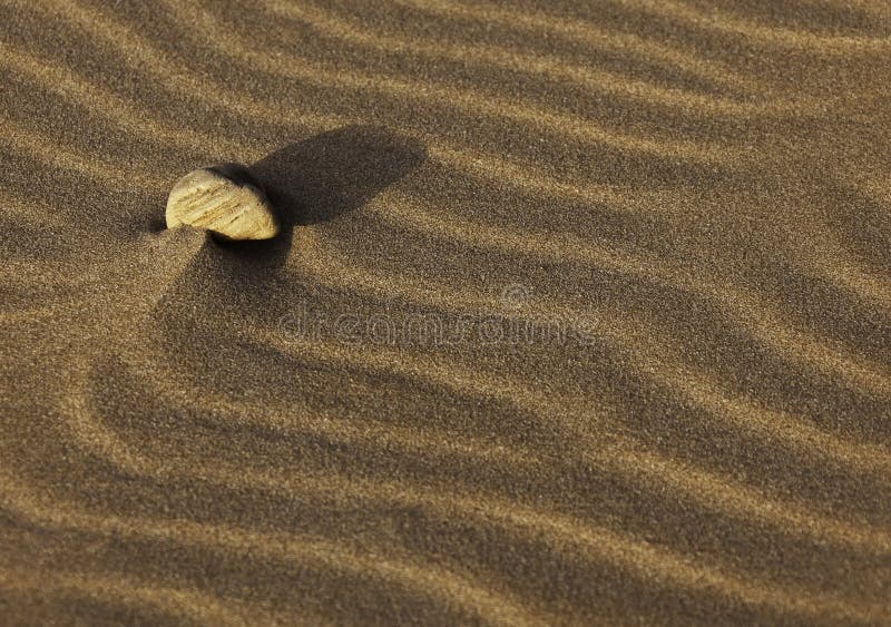 Stone on sand