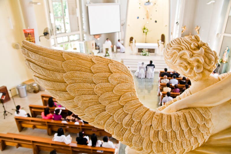 Stone statue of angel overlooking wedding ceremony