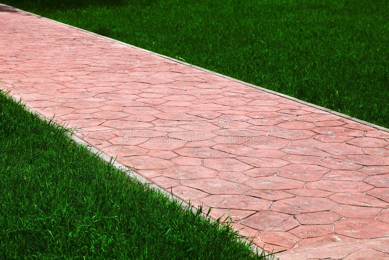 Stone Tile Walkway Curve Arcing in the Park among Green Plants of