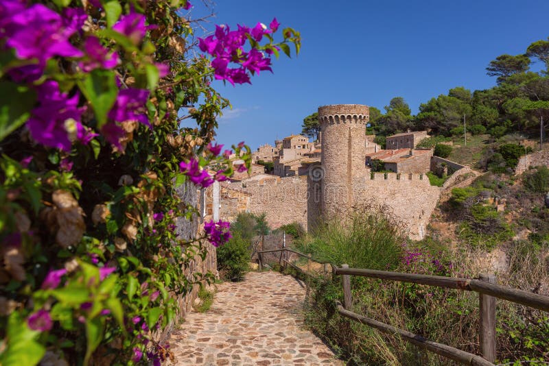 Stone tower and flowers in Tossa de Mar Spain stock photos