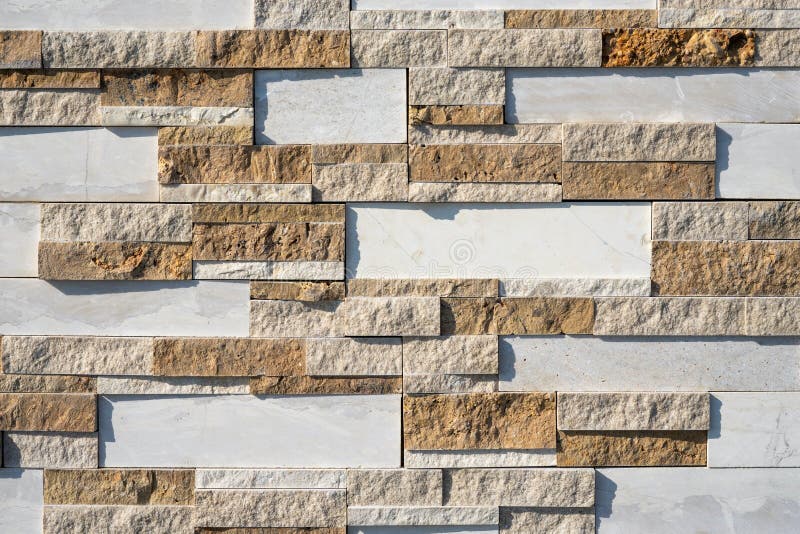 Stone wall brick texture background beige and white surface facade. Close - up