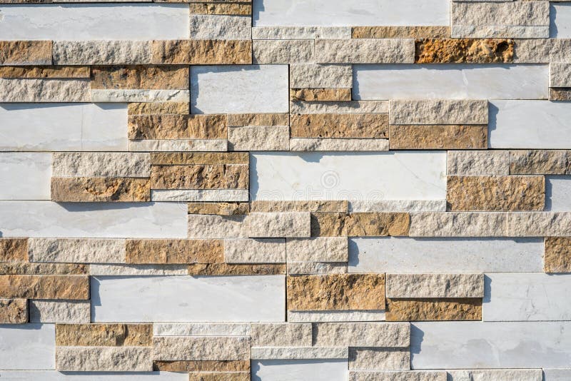 Stone wall brick texture background beige and white surface facade. Close - up.