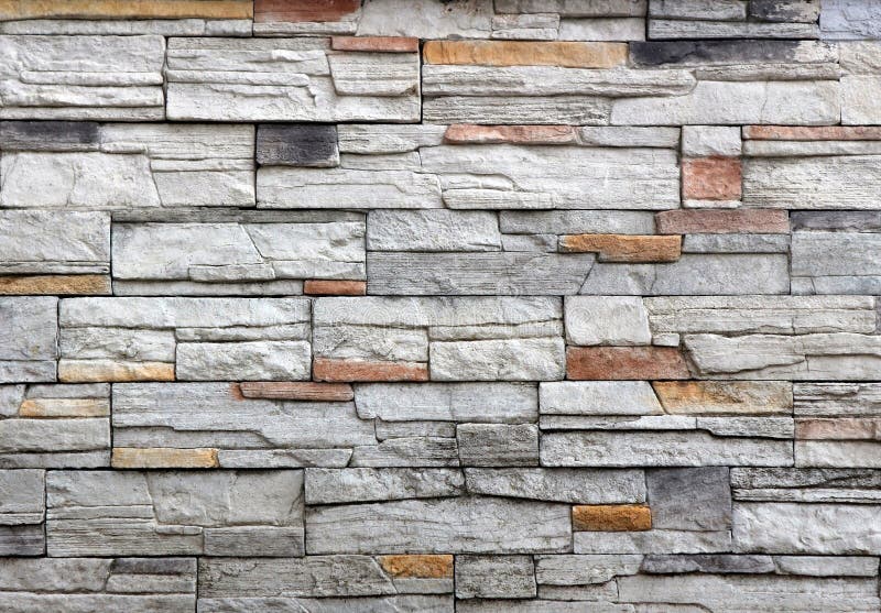 Stone wall cladding made of gray rock mixed with red and black stripes