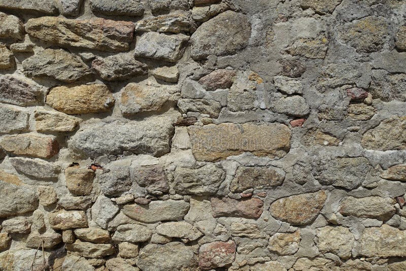 Stone Wall Different Types and Sizes of Stones Background Stock Image