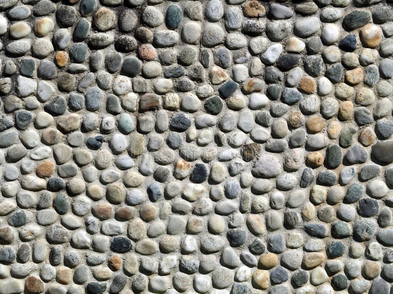 Stone Wall Made of Oval Shape Pebbles of Various Colors. Close Up ...