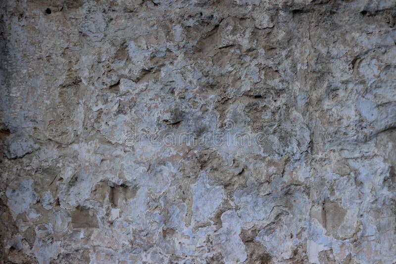 Stone Wall with a Multilayered Old Tumbling Whitewash Texture Stock