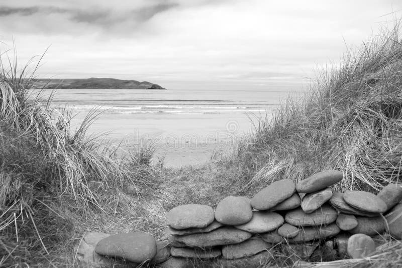 Stone wall shelter on a beautiful beach in black and white