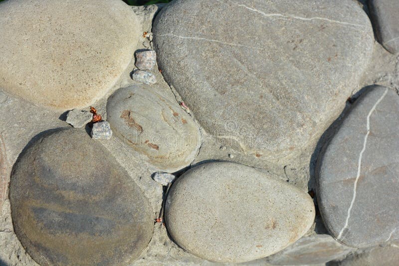 Construction, architecture, repair work. Beautiful road, pavement laying. Large brown, gray natural stones are cemented. royalty free stock photo