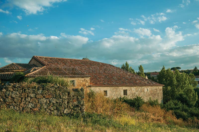 Stone wall and a worn house in hilly landscape at Avila stock photo Stone wall and a worn house in hilly landscape at Avila stock photo