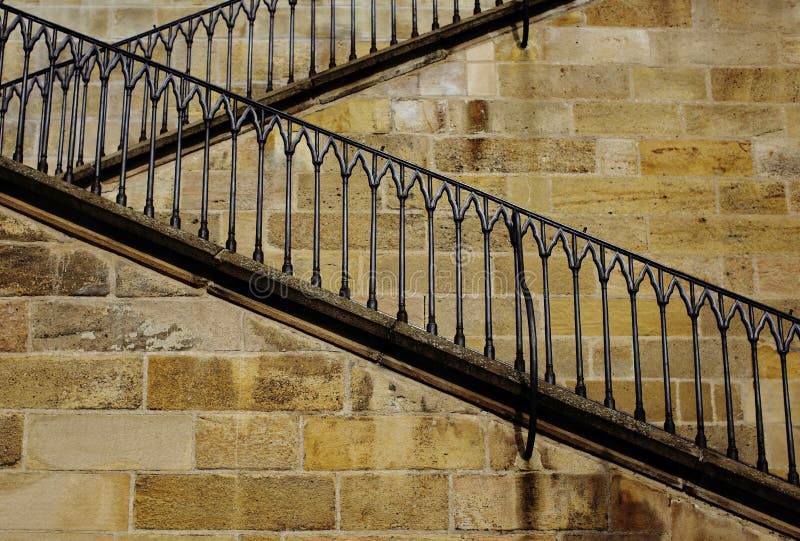 Stone zigzag stairway with iron railing