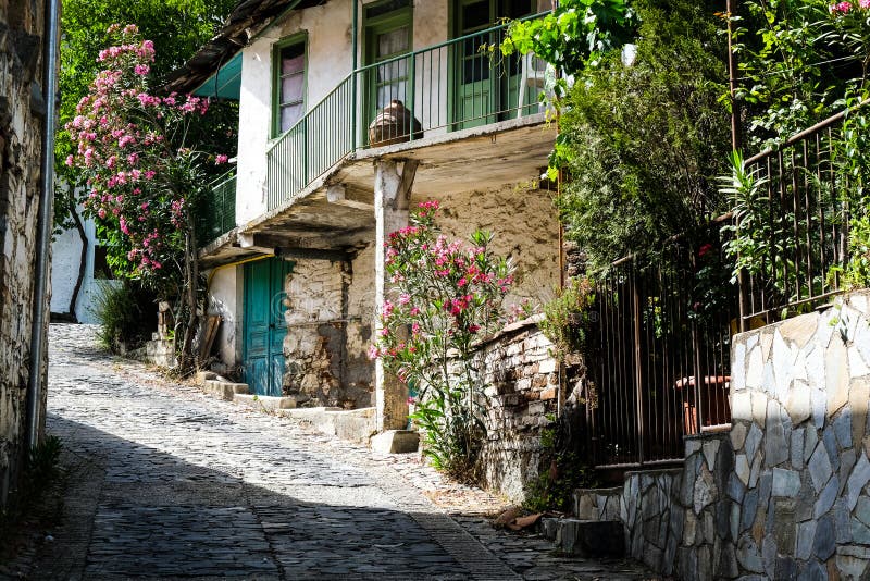 Stoned footpath crossing a traditional village. Stoned houses with wooden doors. Vintage architecture. Palaichori Cyprus