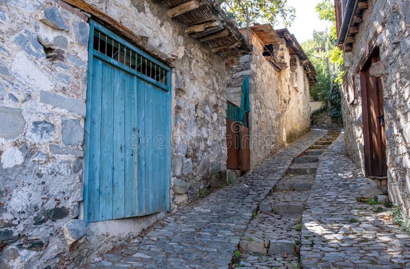 Stoned footpath crossing a traditional village. Stoned houses with wooden doors. Vintage architecture. Palaichori village, Cyprus