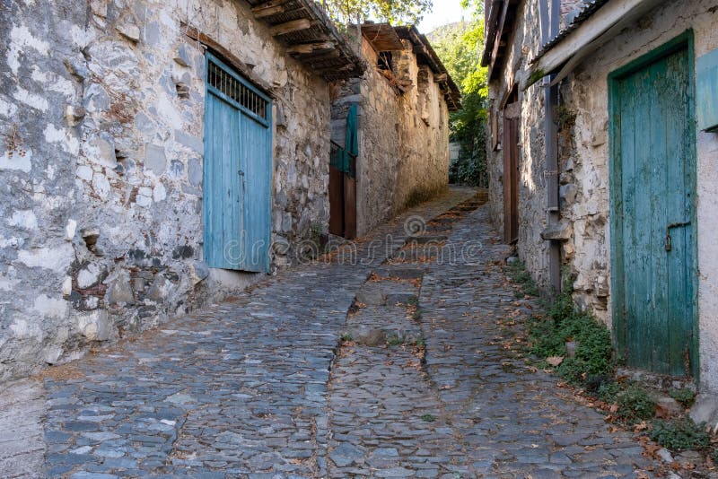 Stoned footpath crossing a traditional village. Stoned houses with wooden doors. Vintage architecture. Palaichori village, Cyprus