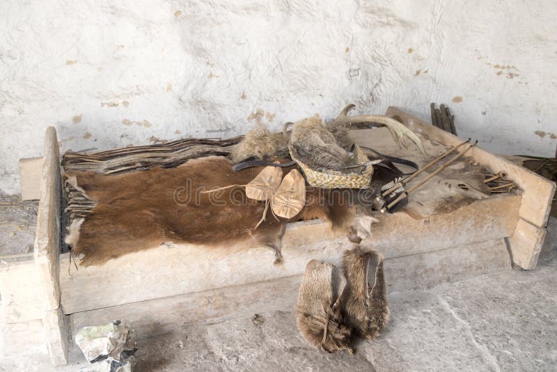 Bedroom with clothes, shoes, tools and fur - authentic material from the neolithic people. Bedroom with clothes, shoes, tools and fur - authentic material from the neolithic people