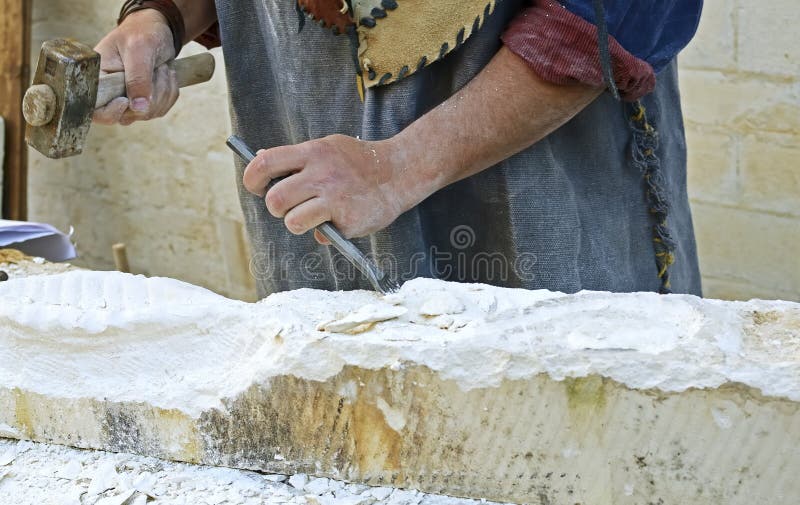 Stonemason working with hammer and chisel. royalty free stock images