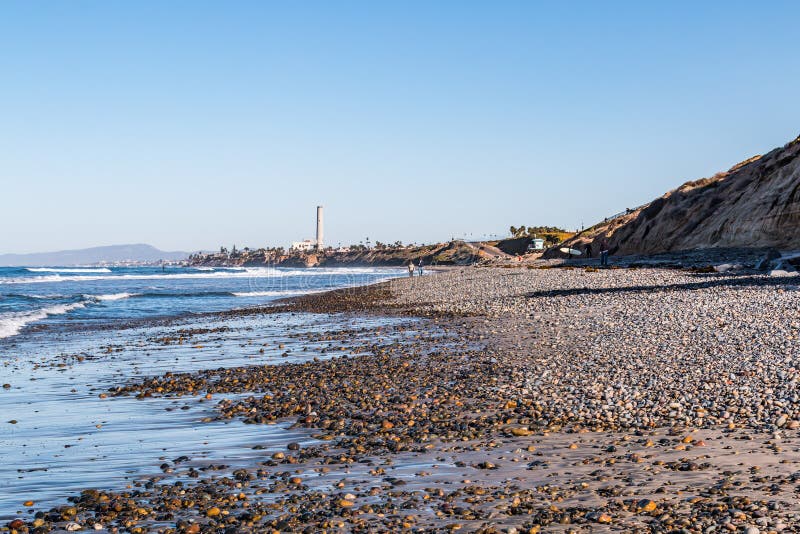 Stones Cover South Carlsbad State Beach with Power Station Landmark Tower