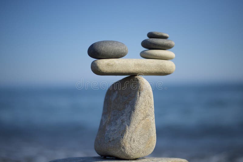 Stones pile background. Scales balance. Balanced stones on the top of boulder. Decide problem. To weight pros and cons.