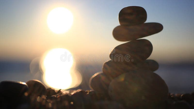 Stones pyramid on beach symbolizing zen, harmony