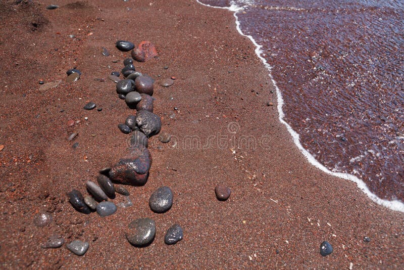 Stones on the red beach. Santorini.