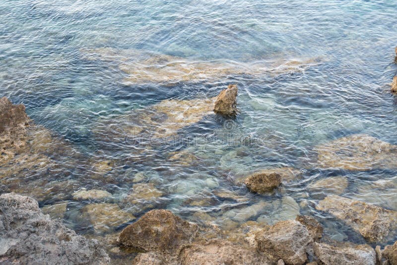 Stones Stick Out of Sea Water Stock Photo - Image of lake, blue: 174863812