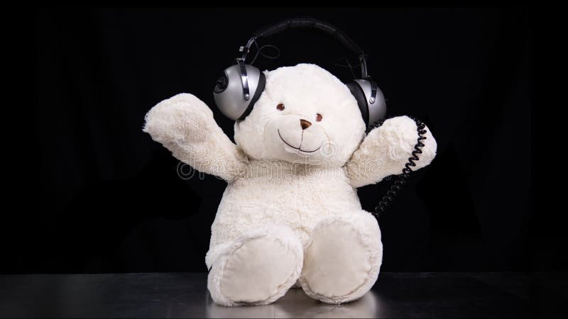 Teddy bear moving around with headphones