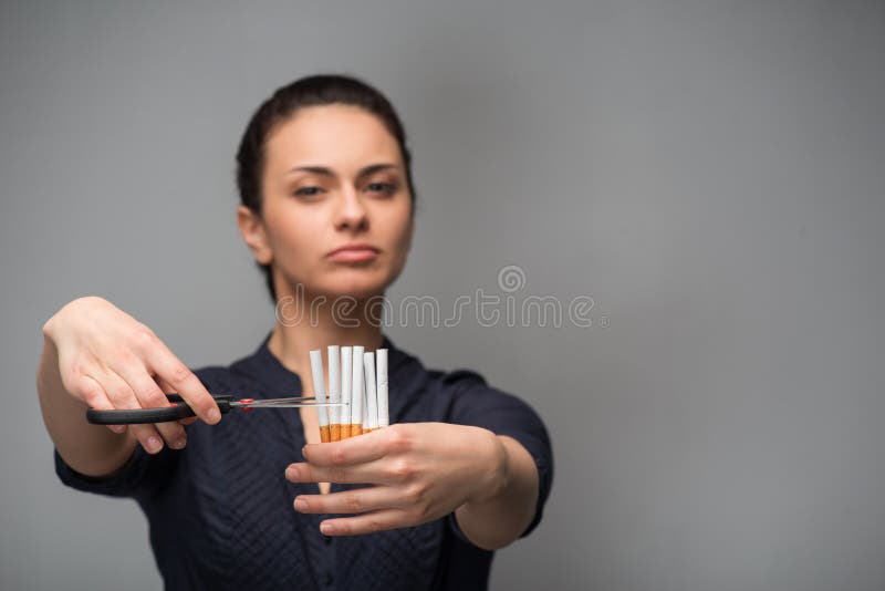 Stop smoking concept. Young woman cut cigarettes stock photography Stop smoking concept. Young woman cut cigarettes stock photography