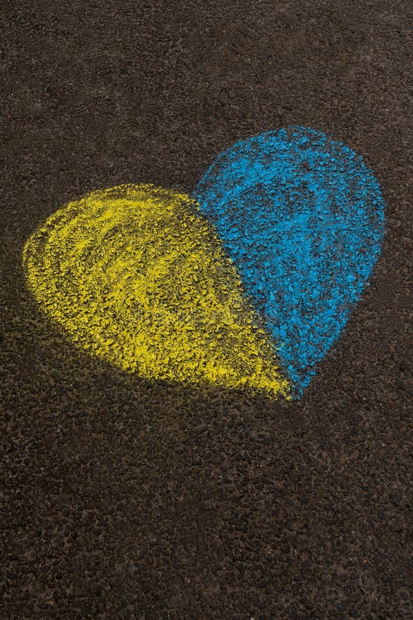 Stop the war in Ukraine. Stop Russia. A yellow-blue heart painted on the pavement as a symbol of peace, the Ukrainian flag and independence. High quality photo