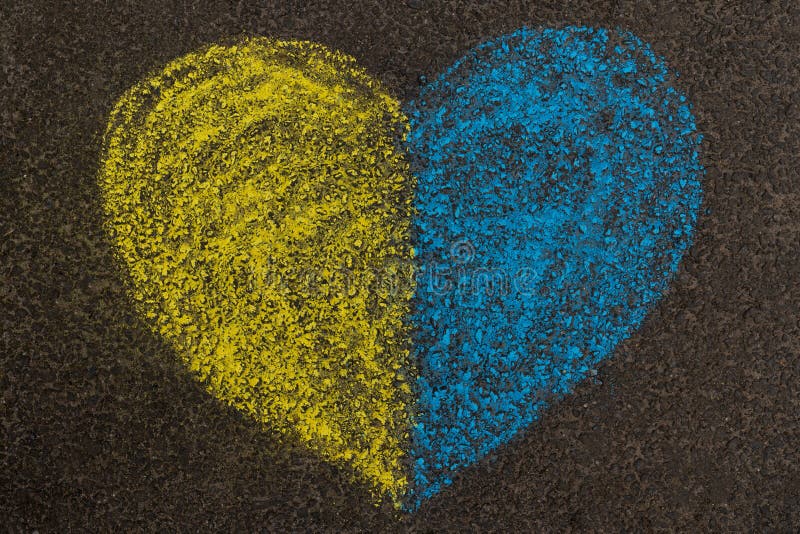 Stop the war in Ukraine. Stop Russia. A yellow-blue heart painted on the pavement as a symbol of peace, the Ukrainian flag and independence. High quality photo