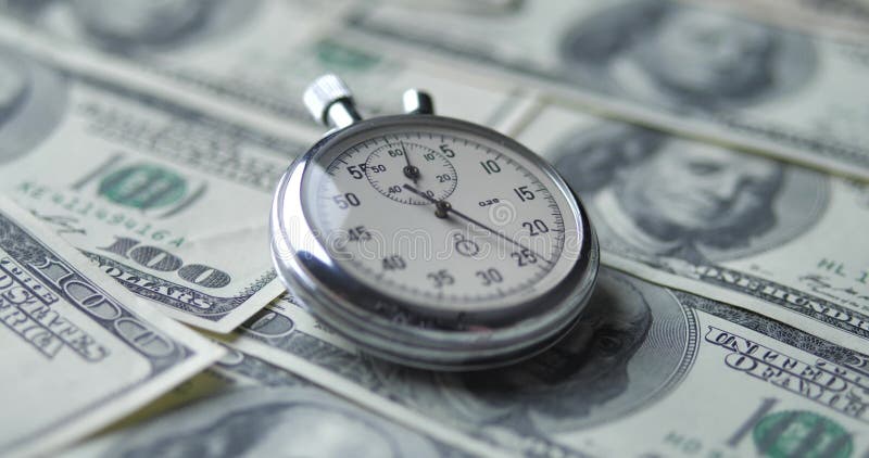 Stopwatch ligger på dollar. tid är penningbegreppet. stock video