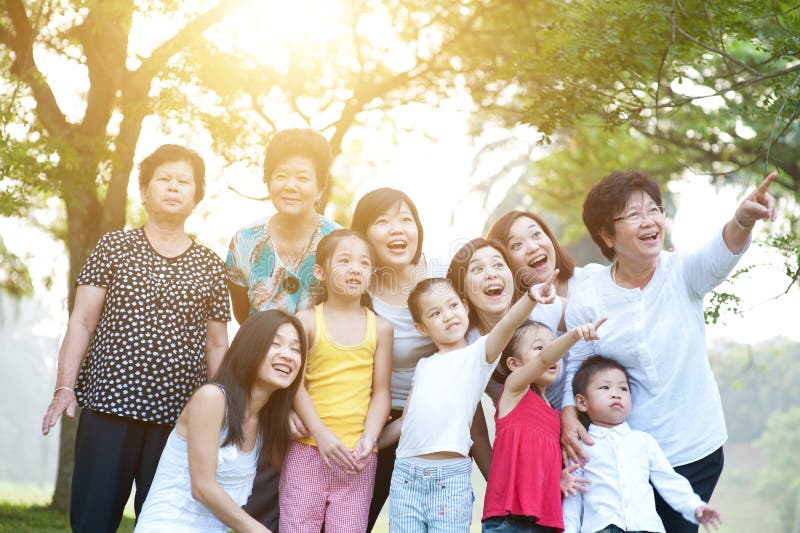 Stor grupp av den asiatiska mång- utvecklingsfamiljen som har utomhus- gyckel arkivbild Stor grupp av den asiatiska mång- utvecklingsfamiljen som har utomhus- gyckel arkivbild