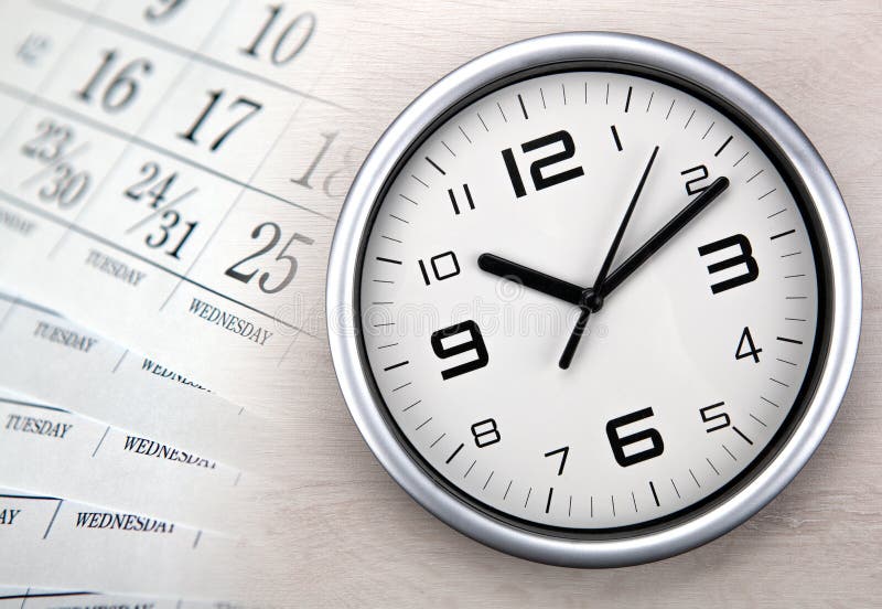 Large white clock face with calendar sheets closeup. Large white clock face with calendar sheets closeup