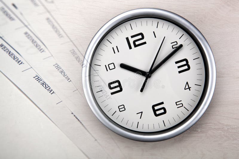 Large white clock face with calendar sheets closeup. Large white clock face with calendar sheets closeup