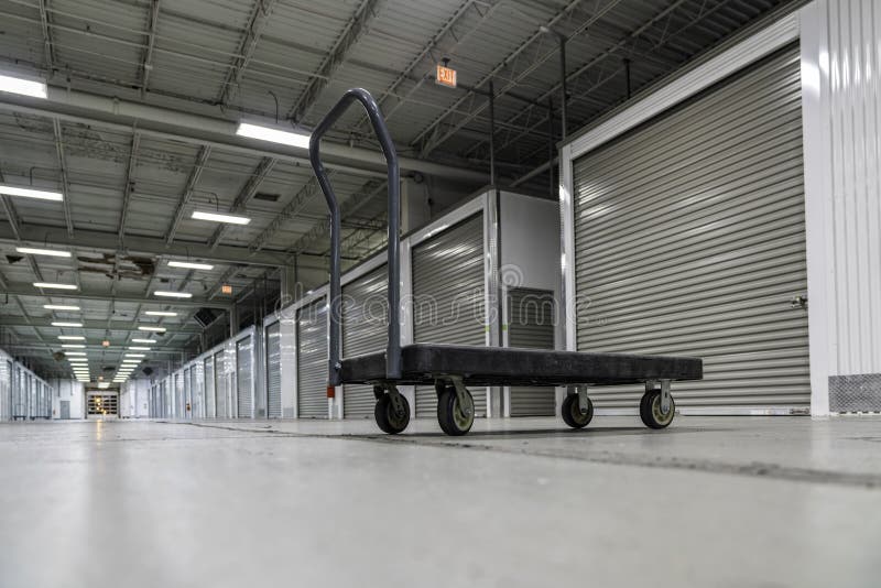 Storage facility corridor with empty platform truck ready to carry boxes or equipment