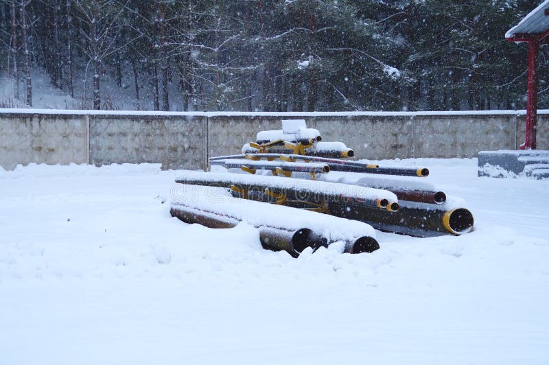 Storage racks of metallic pipes of different diameters stock photos